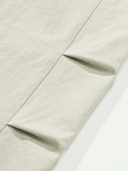 Balloon-fit trousers in light gray with subtle pleating detail.