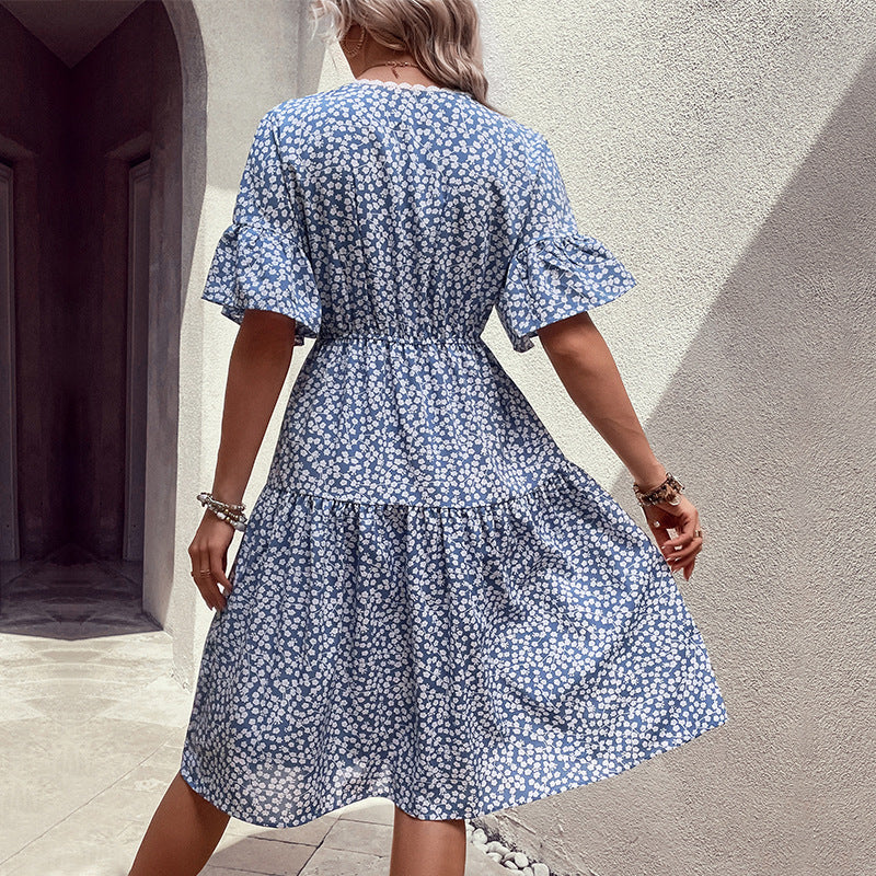 Light blue ditsy floral tiered midi dress with flutter sleeves and a cinched waist.