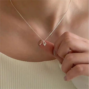 Sterling silver necklace with dainty heart lock and key charms.