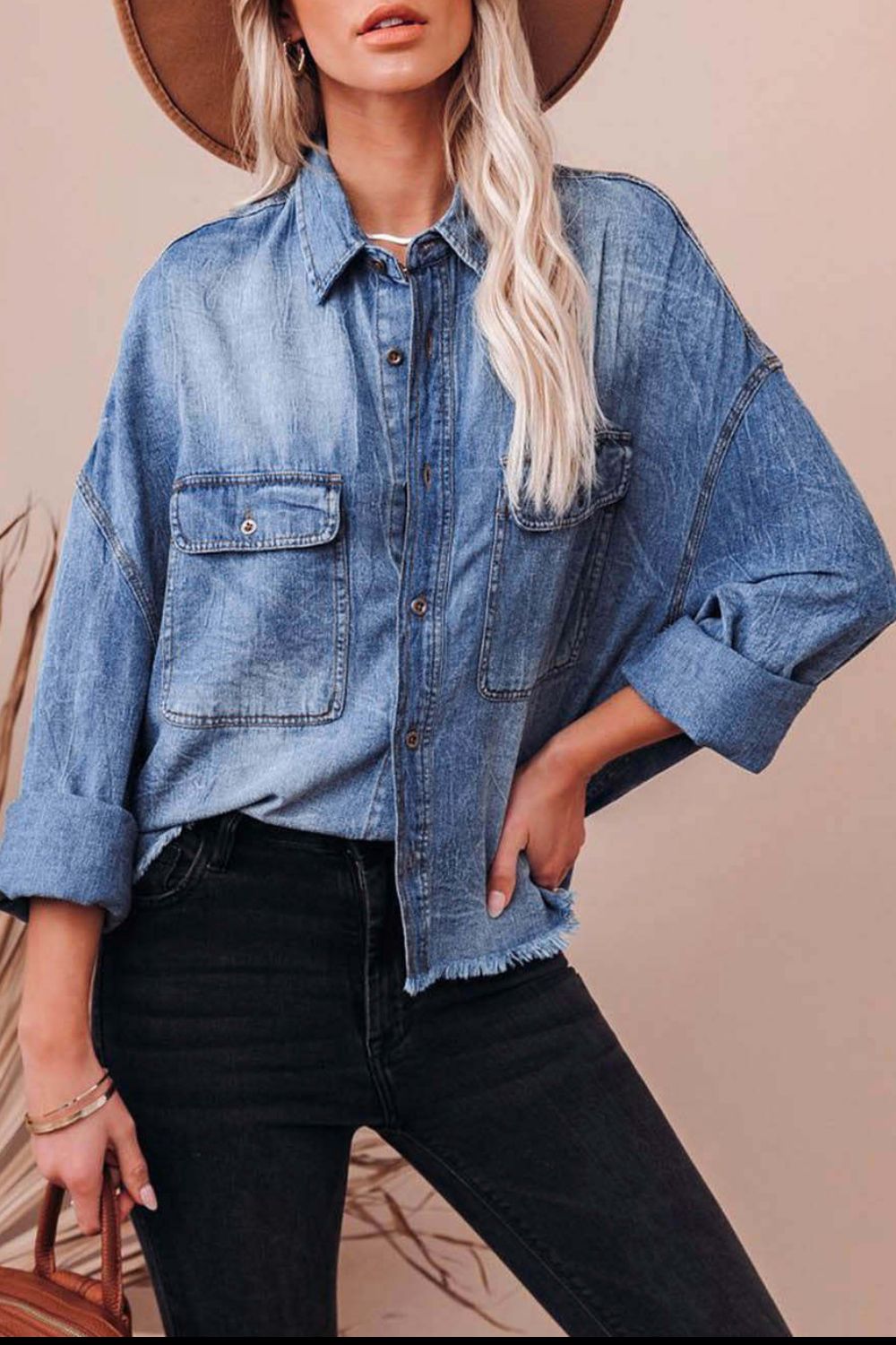Light wash denim oversized shirt with raw hemline and button-down front.
