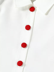 White baby top with red button detail and collar