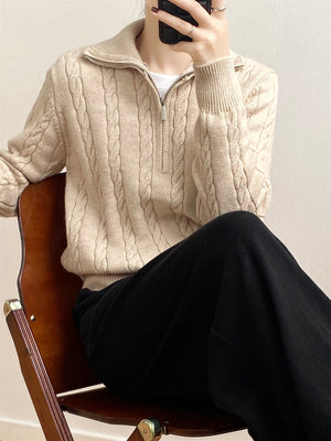 Beige cable knit quarter-zip pullover sweater with a collared neckline and silver zipper.