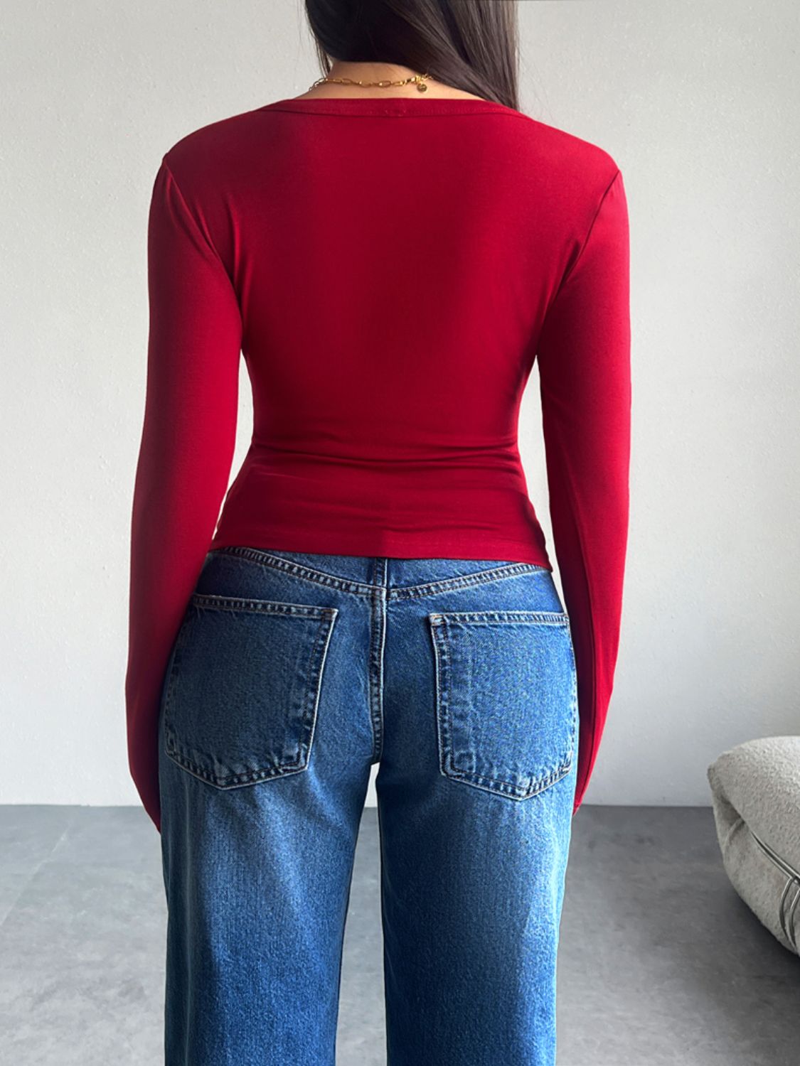 Scarlet button-up cardigan with long sleeves, shown from the back.