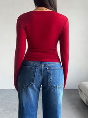 Scarlet button-up cardigan with long sleeves, shown from the back.