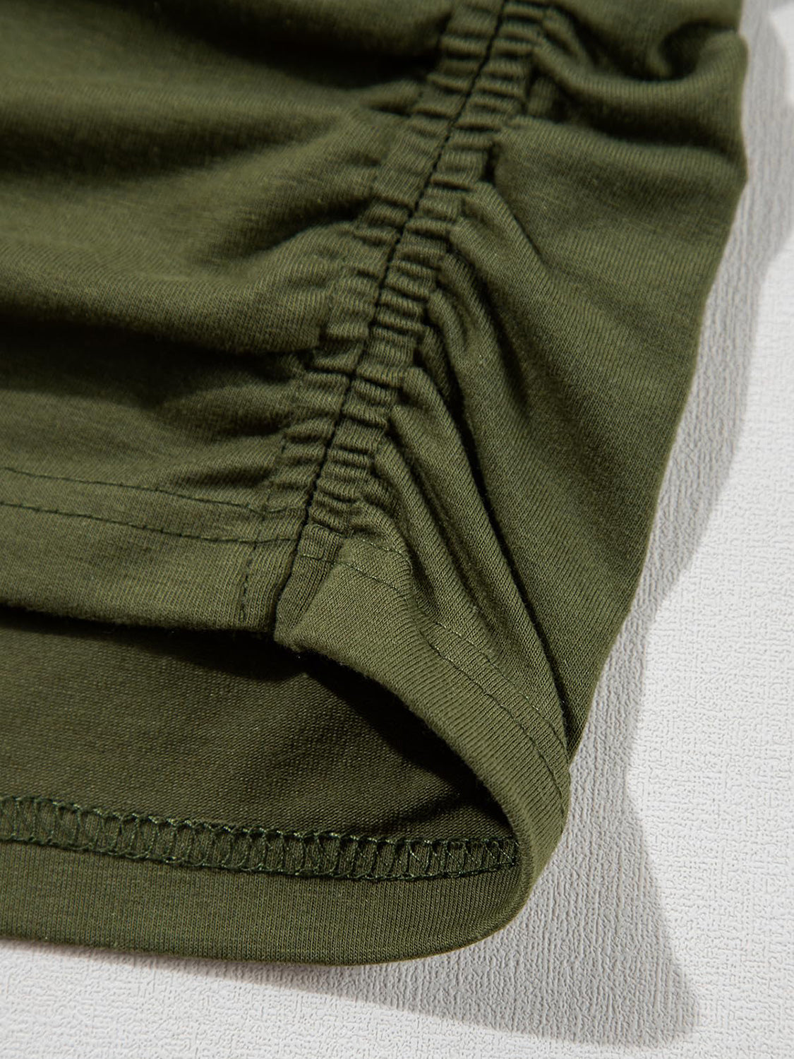 Moss green tee with ruched front detail and visible stitching