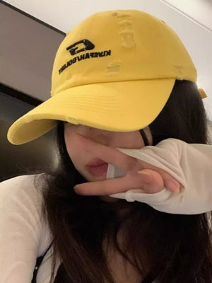 Yellow distressed baseball hat with embroidered logo detail