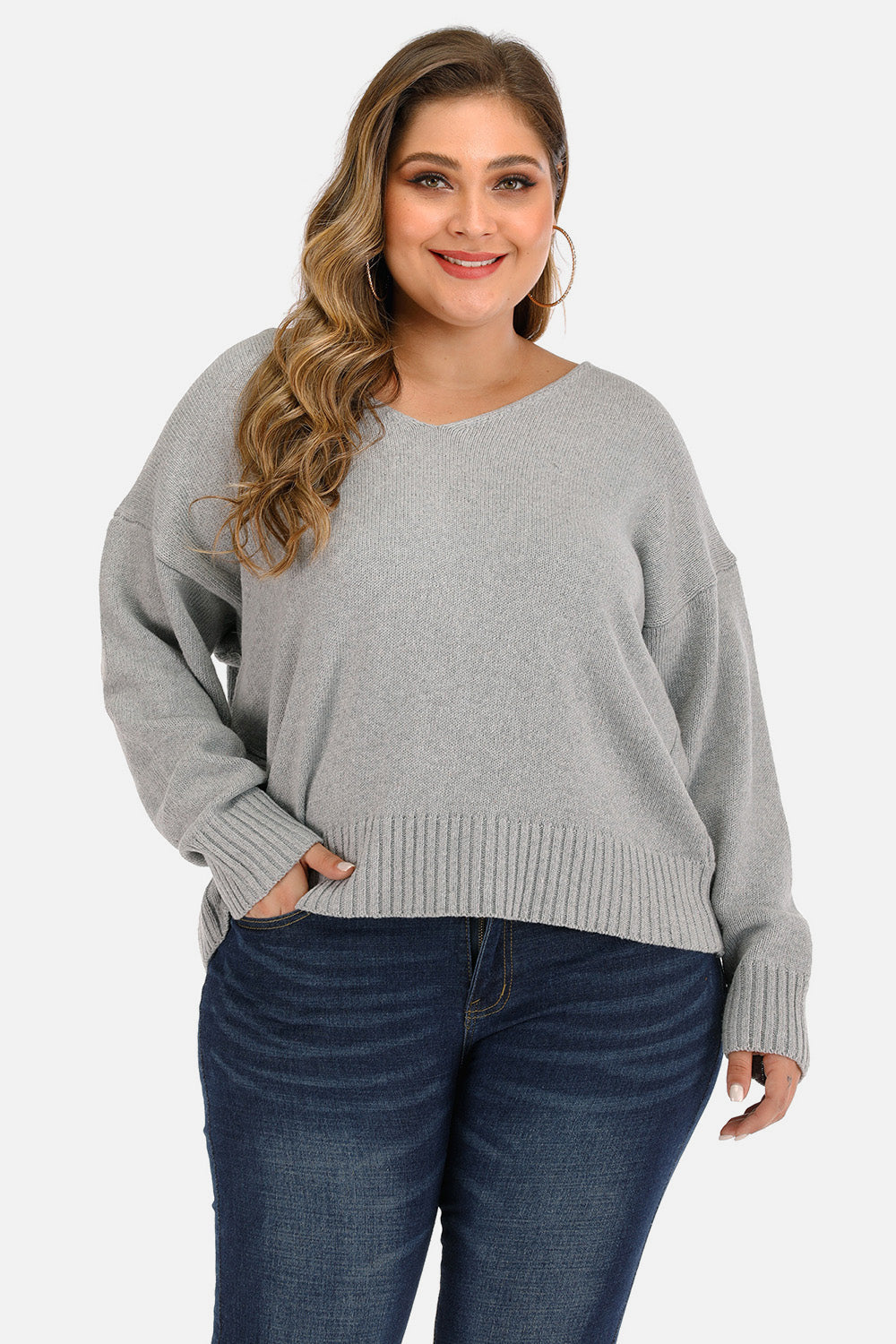Open back tie knit sweater in cloudy blue with v-neck and long sleeves.