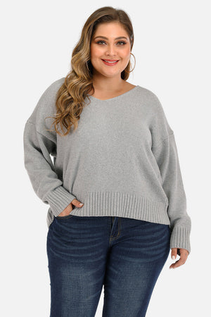 Open back tie knit sweater in cloudy blue with v-neck and long sleeves.