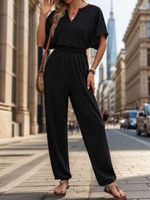 Black jumpsuit with dolman sleeves, V-neck, elastic waist, and wide legs.