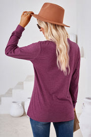 Burgundy Henley neckline jersey top with long sleeves.