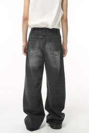 Oversized wash denim trousers in charcoal grey with a baggy fit and classic five-pocket styling.