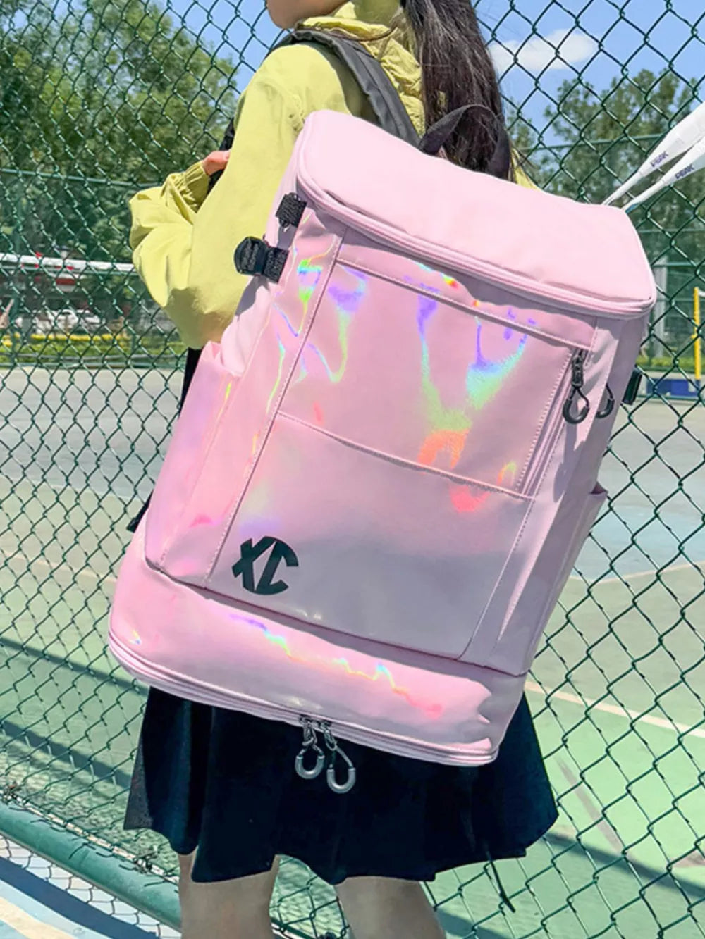 Pink travel organizer bag with iridescent panel and black logo