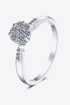 Silver floral cluster moissanite engagement ring with small accent stones on the band.