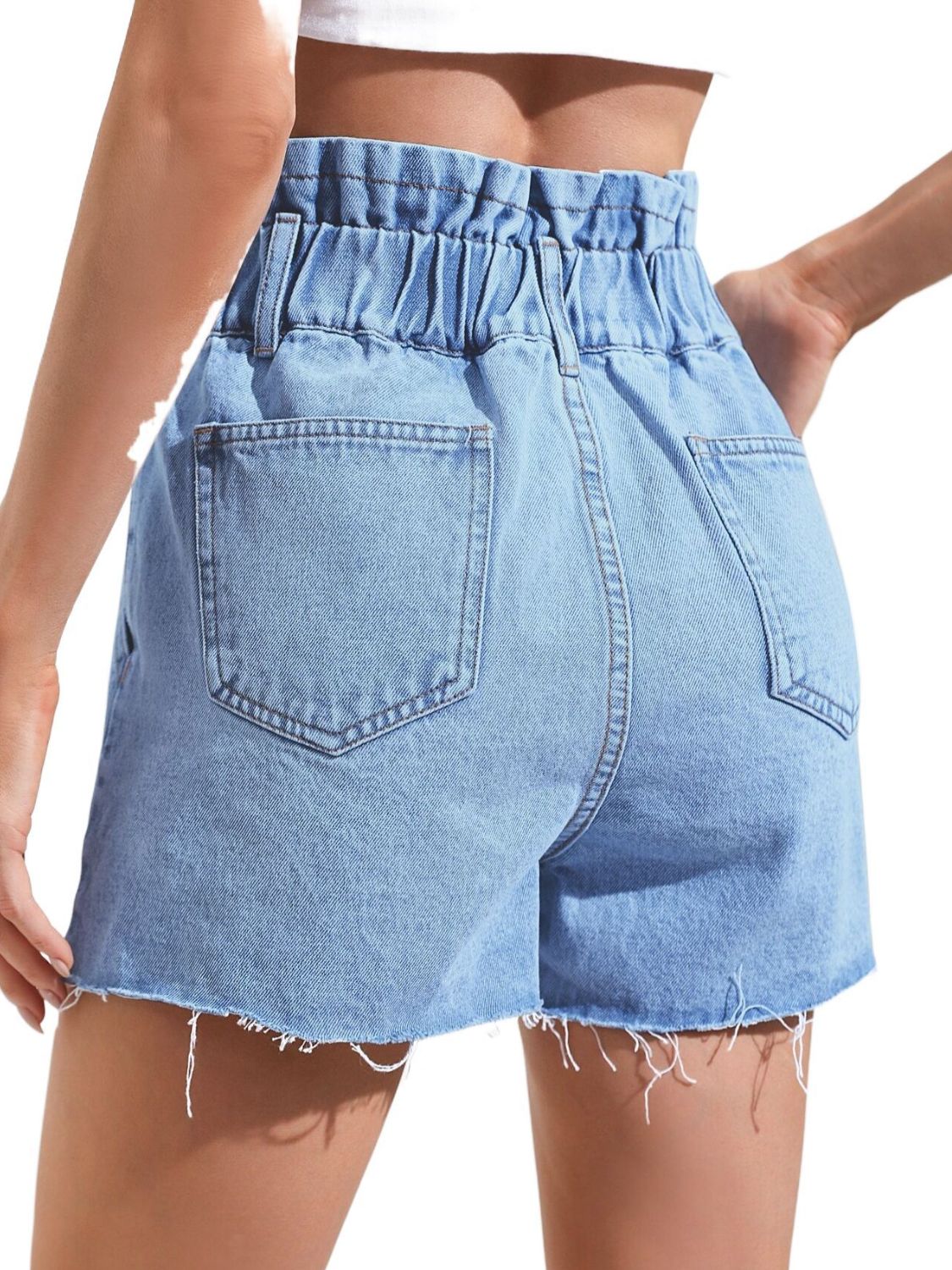 Medium wash denim paperbag shorts with frayed hem and back pockets.