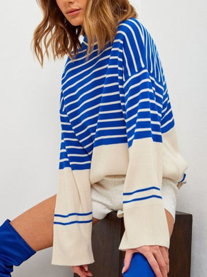 Colorblock stripe knit sweater with bell sleeves in blue and cream.