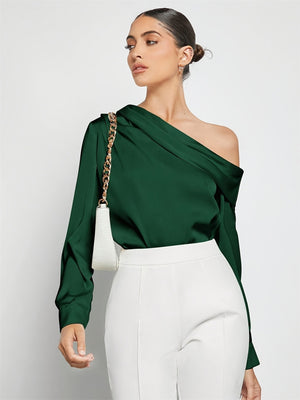 Dark green silk-effect blouse with asymmetric neckline and draped detail.