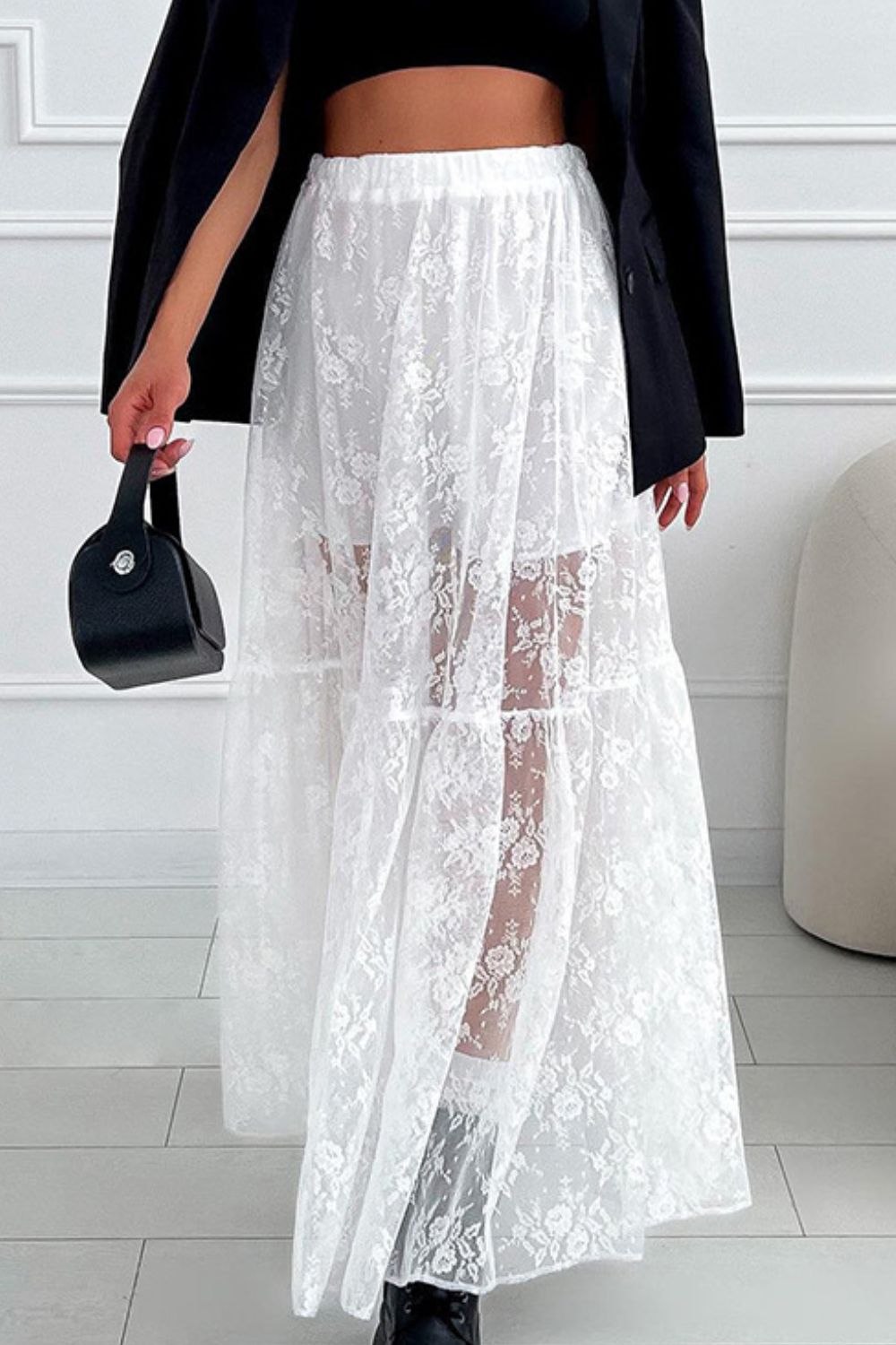 White floral lace maxi skirt with tiered design and sheer panels.