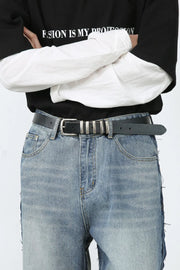Paneled wide-leg denim trousers in medium wash with distressed hem detail.