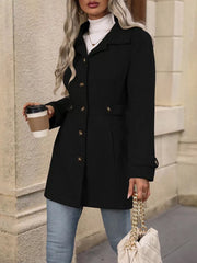Black button-up trench coat with cinched waist and gold buttons, worn with jeans.