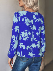 Royal blue floral tie-neck blouse with long sleeves and a relaxed fit.