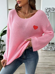 Pink slouchy boatneck knit sweater with embroidered red heart detail.