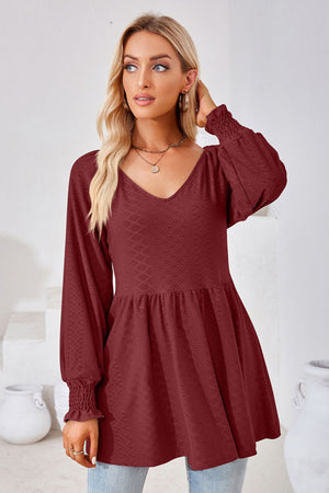 Burgundy textured babydoll blouse with v-neck and smocked cuffs