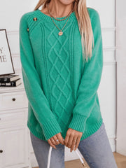 Green cable knit raglan sweater with button shoulder detail and crew neck.
