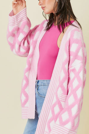 Open knit cardigan in blush pink with diamond jacquard pattern and ribbed trim.
