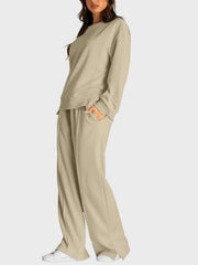 Tan loungewear set with crewneck sweatshirt and slit-front wide-leg trousers.