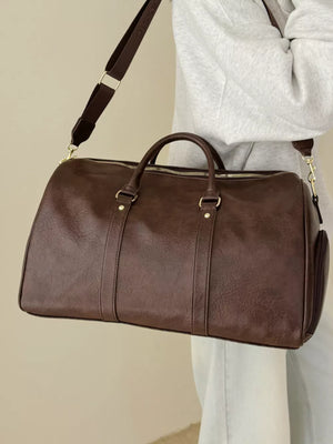 Classic large brown pu leather travel bag with adjustable strap and gold hardware.