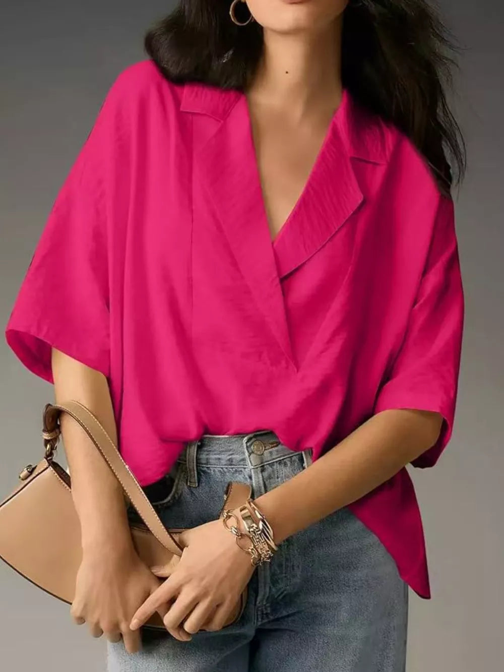 Hot pink V-neck half sleeve shirt with a relaxed fit, styled with jeans and a handbag.