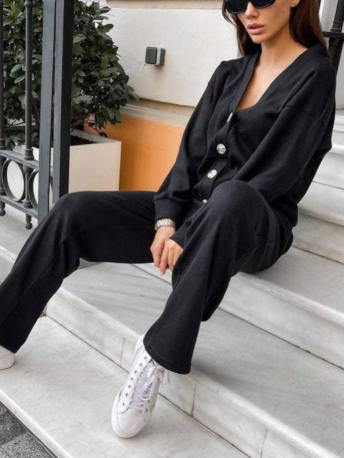 Black button-front lounge set with wide-leg pants and a V-neck cardigan.