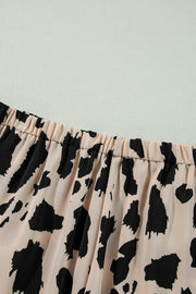 Animal print satin pajama set with elastic waistband and leopard pattern.