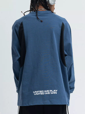 Relaxed fit long-sleeve tee in royal blue with black contrast panels and text graphic on back.