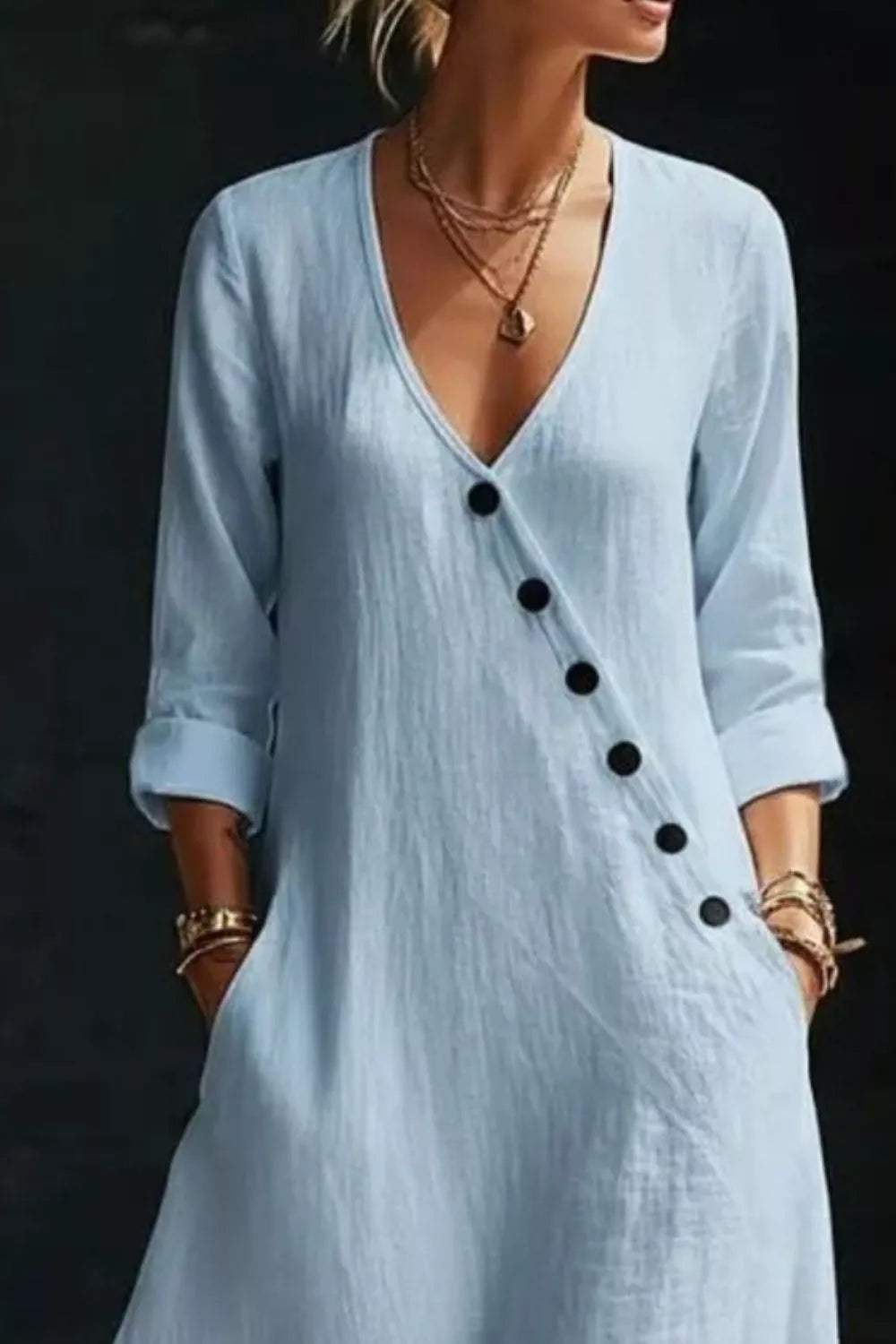 Light blue maxi dress with V-neck, button detail and cuffed sleeves.