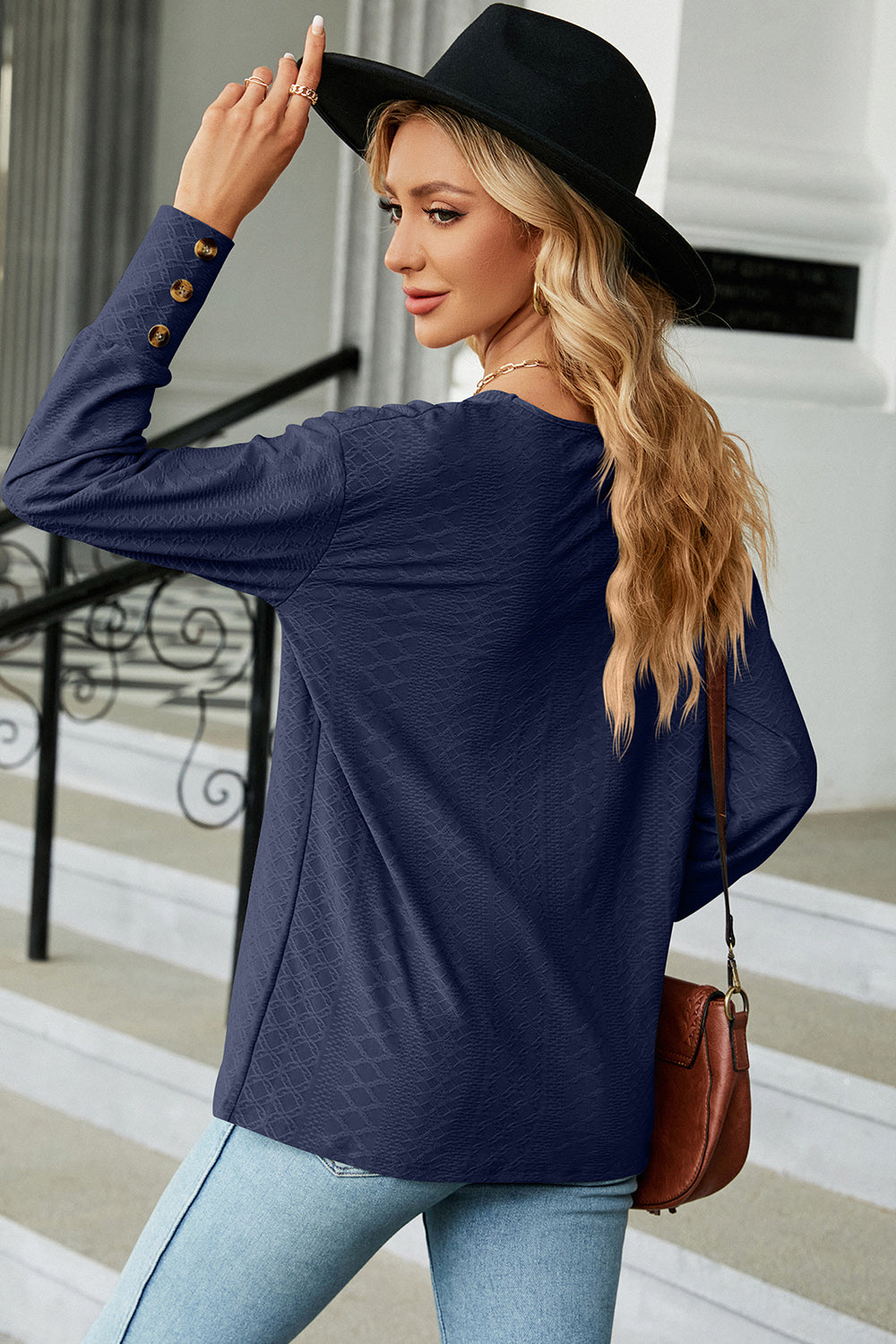 Dark Blue V-neck blouse with diamond texture and button cuffs.