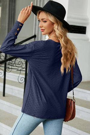 Dark Blue V-neck blouse with diamond texture and button cuffs.