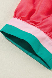 Colorblock puff sleeve blouse in strawberry pink with green and pink trim detail.