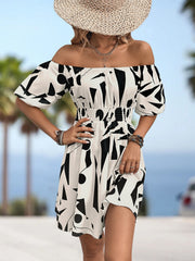 Off-shoulder mini dress with geometric print, shirred waist, and balloon sleeves.