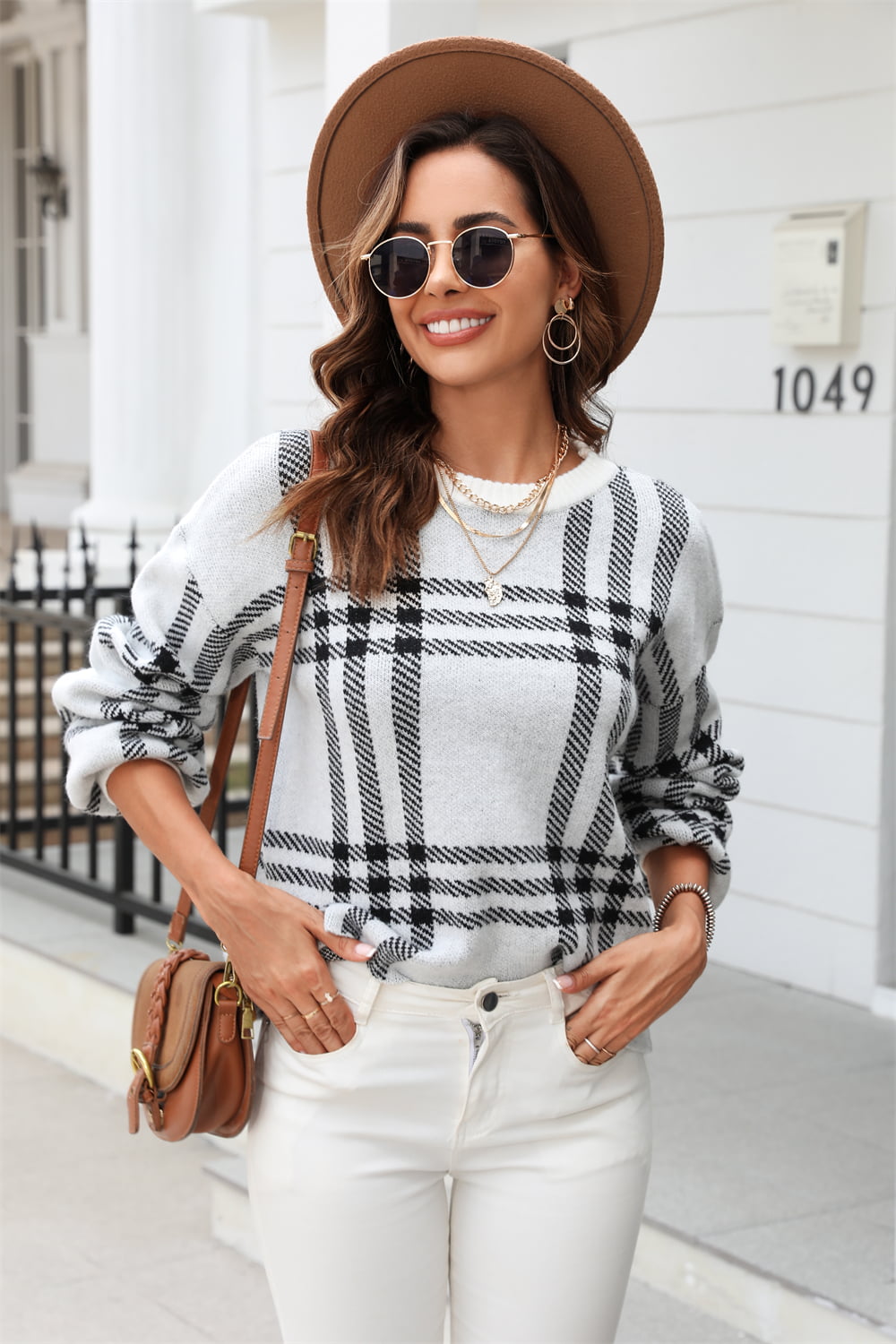 Checked plaid crewneck sweater in light gray acrylic with black pattern.