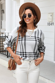 Checked plaid crewneck sweater in light gray acrylic with black pattern.