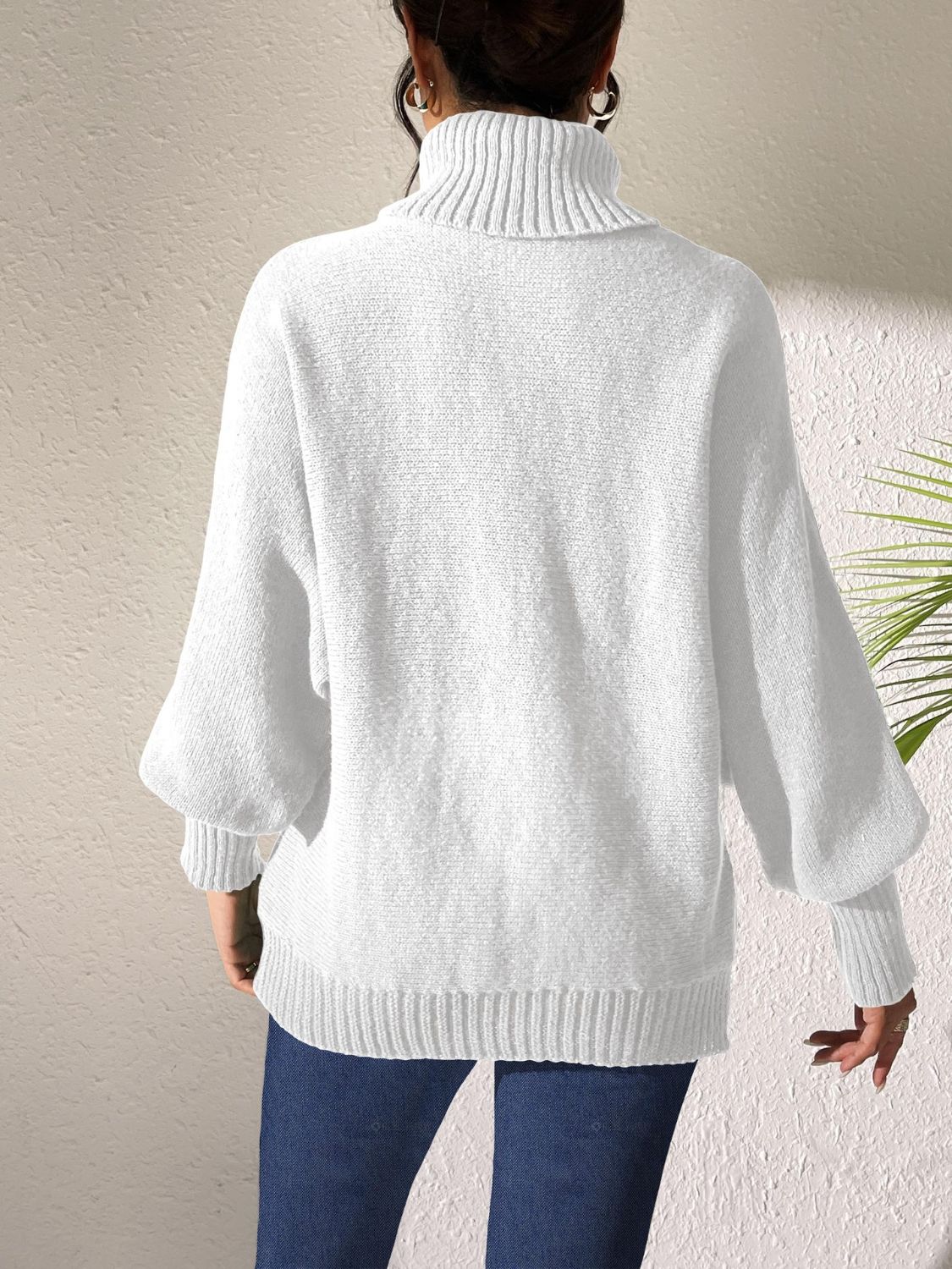 White knit turtleneck sweater with balloon sleeves and ribbed cuffs and hem.