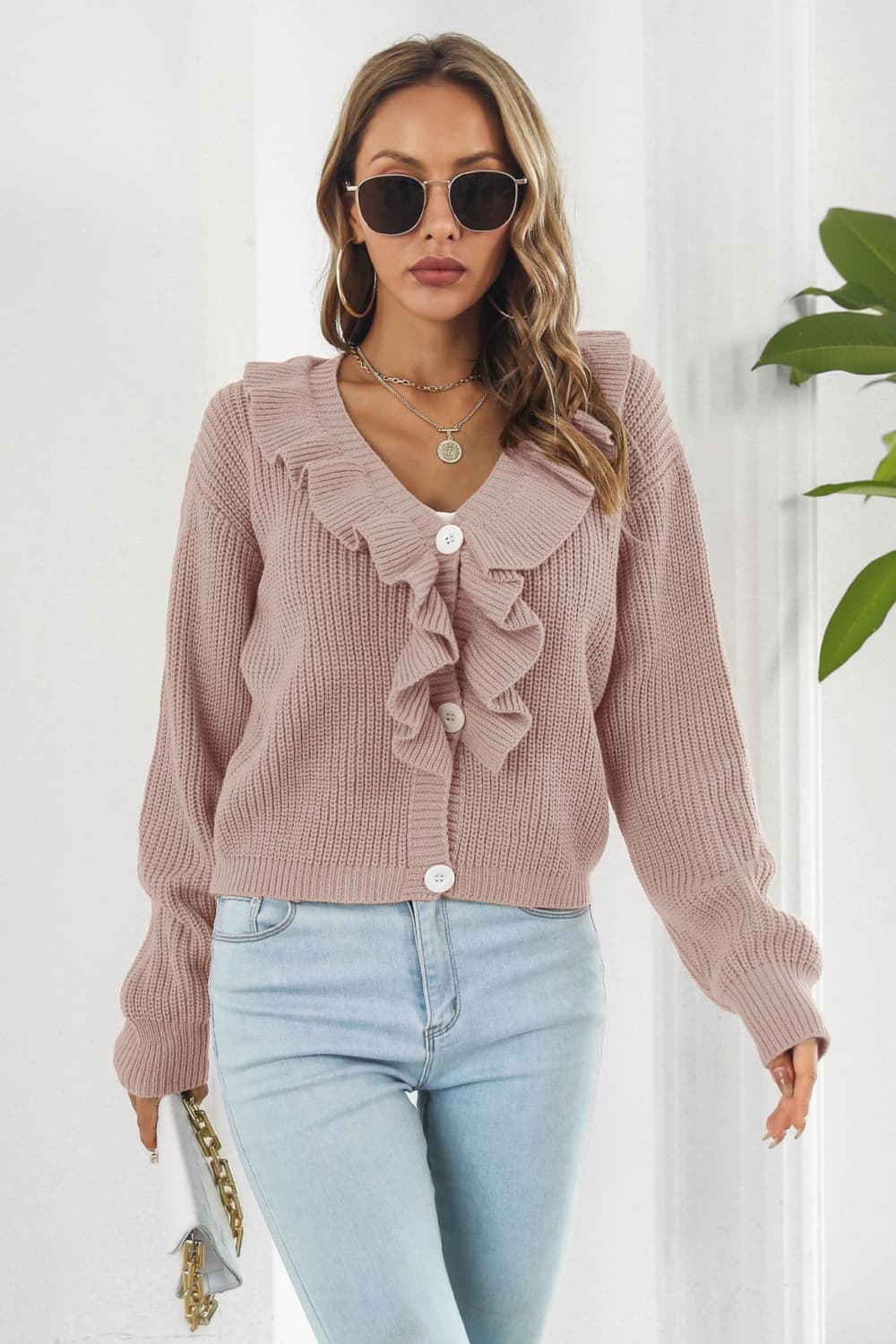 Dusty pink acrylic knit cardigan with ruffled collar and button front.
