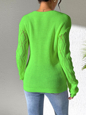 Lime green acrylic knit sweater with openwork diamond pattern on sleeves.