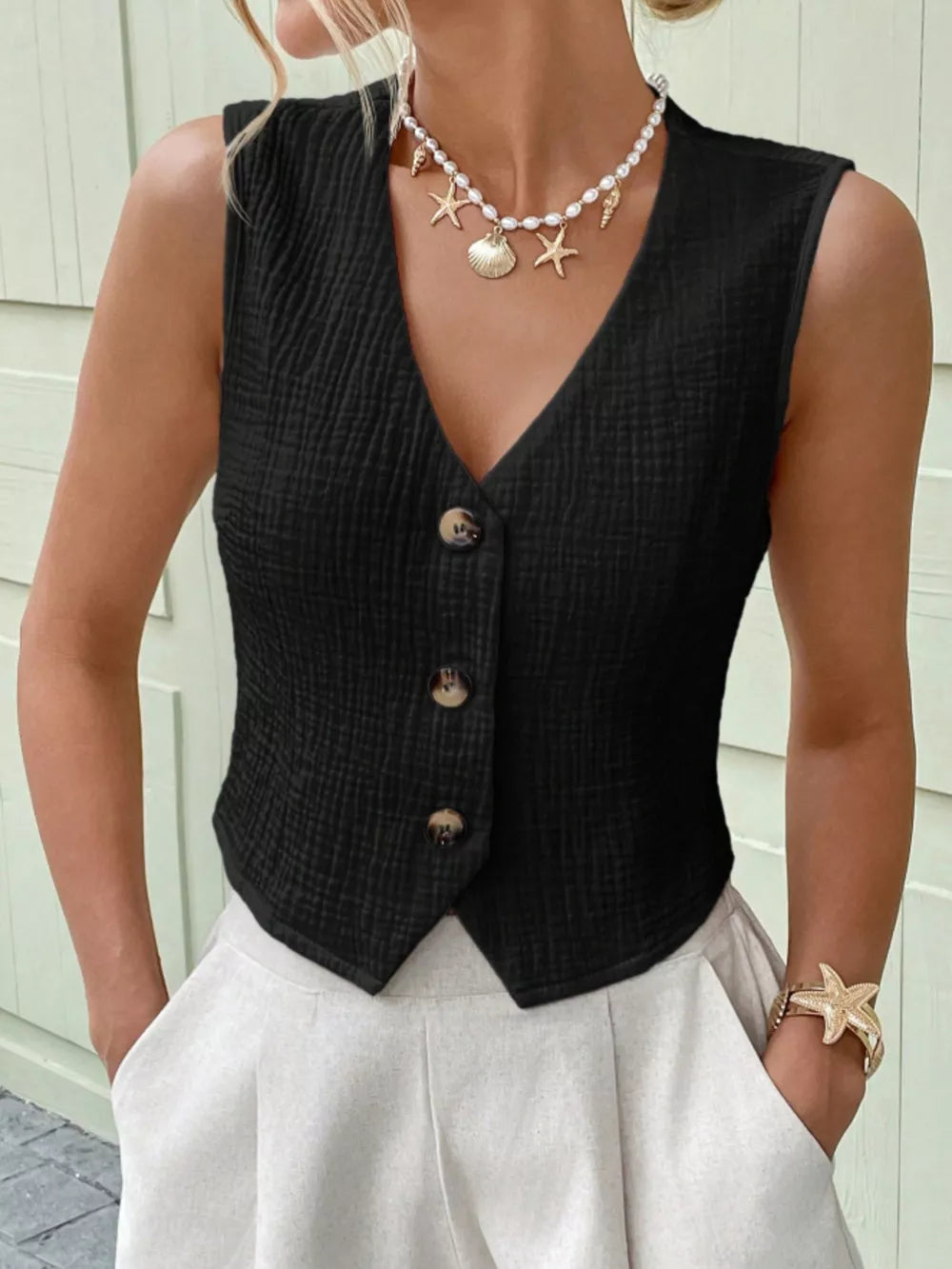 Black textured cotton button vest with V-neck and cropped length.