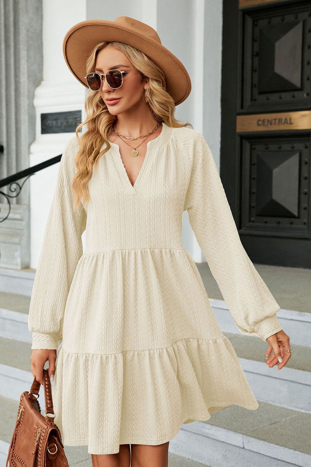 Cream textured babydoll mini dress with voluminous sleeves and tiered hem