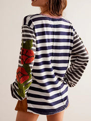 Long sleeve tee with navy and white stripes and embroidered floral detail on sleeve