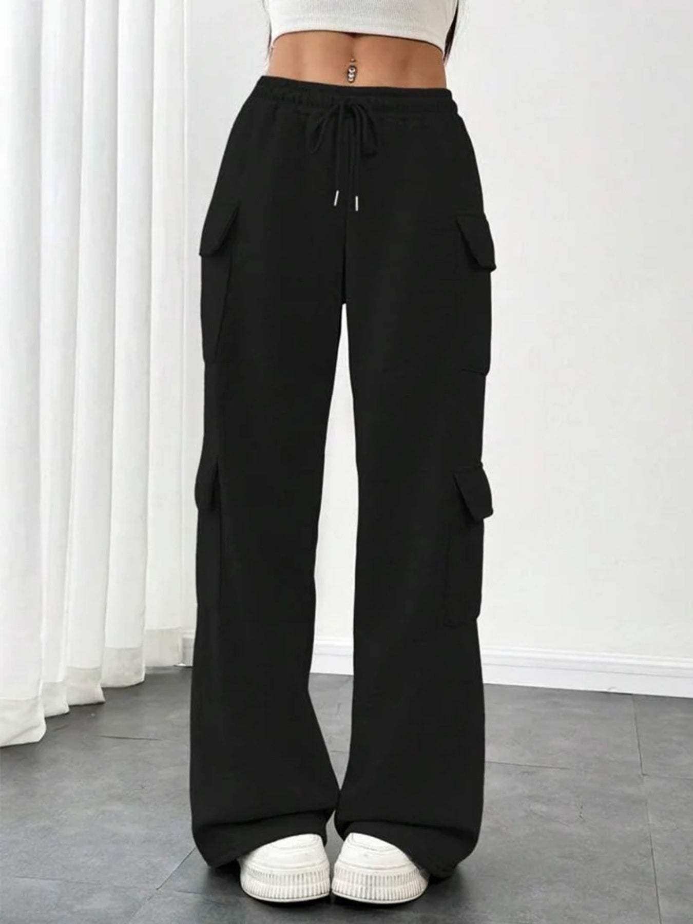 Black relaxed fit cargo pants with drawstring waist and multiple pockets.
