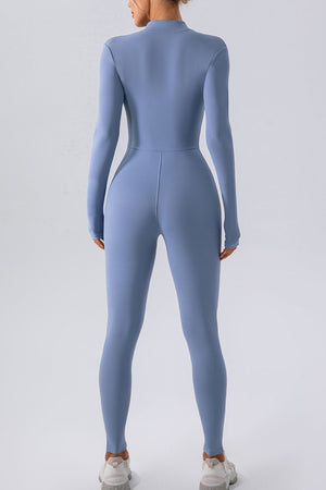 Light blue zip-front bodycon jumpsuit with long sleeves and high neckline.