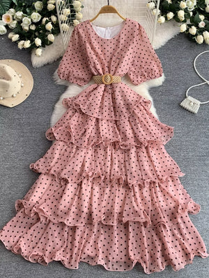 Pink polka dot tiered chiffon dress with puff sleeves and a woven belt.